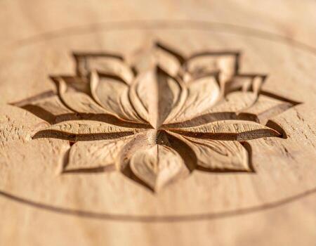 Intricate Lotus Flower Carving on Light Wood Surface Macro Detail. photo