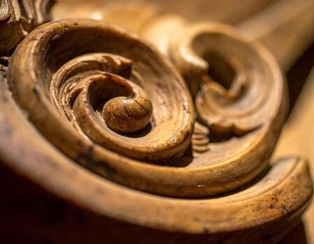 Intricate Wooden Scrollwork Detailed Macro Shot of Carved Ornament. photo