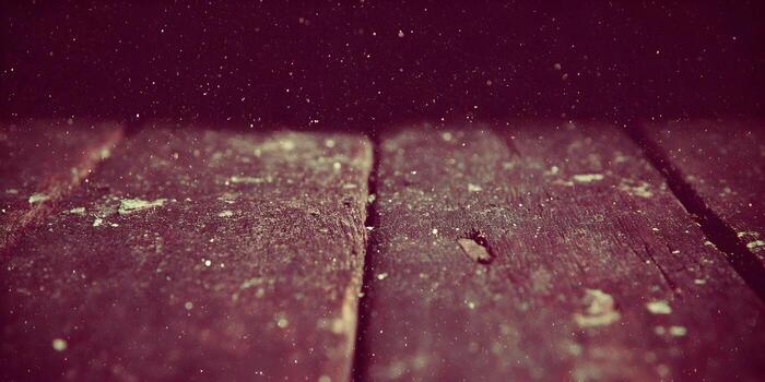 An atmospheric abstract background of dusty dark wood with sparkling light particles floating above photo