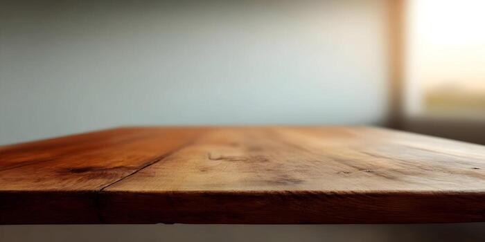 A rustic wooden table surface with a blurred light grey background and soft window light photo