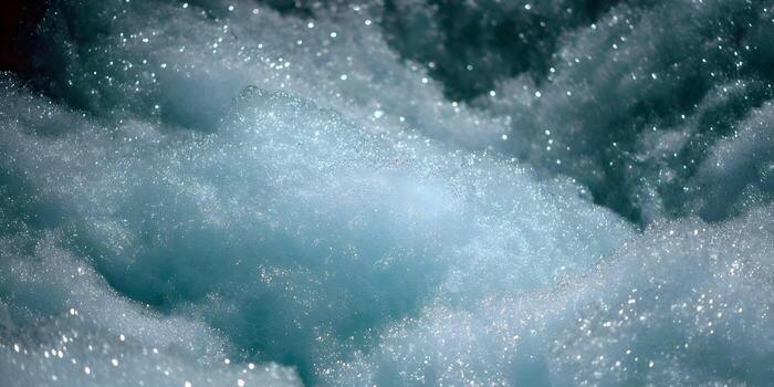 A refreshing close up view of sparkling blue water foam and bubbles creating an abstract texture photo