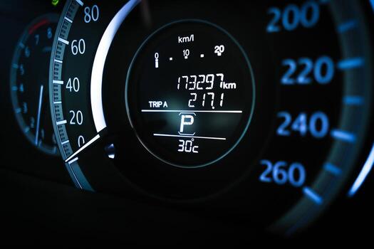 Close up of digital car dashboard odometer showing 173,297 km mileage, trip meter, parking gear indicator and 30 Celsius temperature display, automotive instrument cluster and vehicle data concept photo