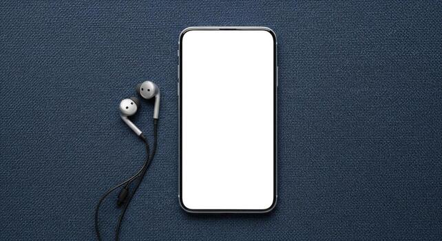 Flat lay of modern smartphone with blank white screen and earphones on a blue textured background photo