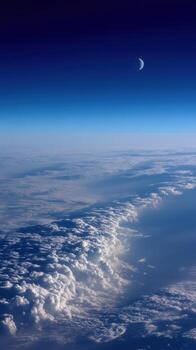 Serene View of Earth Clouds with Crescent Moon in Dusk Sky photo