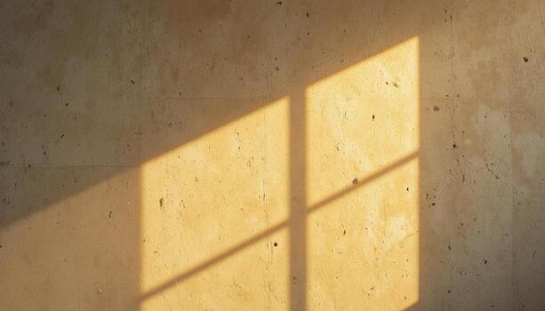 Sunlight Casts Warm Shadows Through a Window Onto a Textured Wall photo