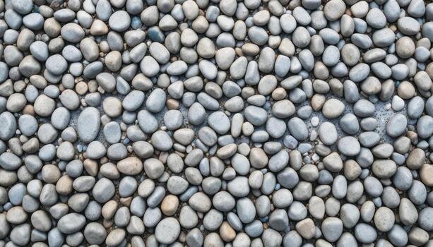 Smooth River Stones Create a Decorative Pattern for Landscaping and Pathways in a Tranquil Outdoor Setting photo