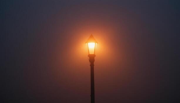 Mysterious Glow of a Streetlamp Cutting Through Thick Fog During Twilight photo