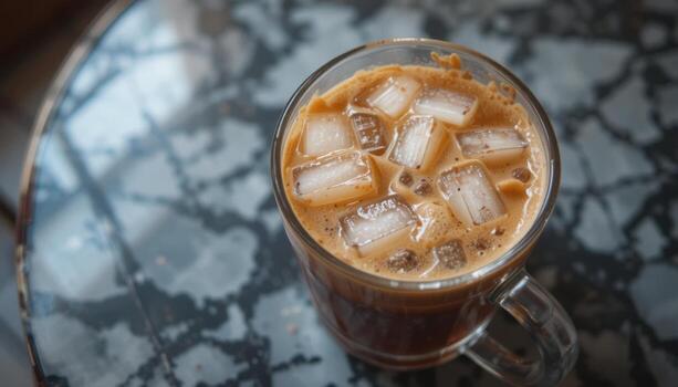 Iced Coffee Served in a Clear Mug on a Patterned Table With a Cozy Atmosphere photo