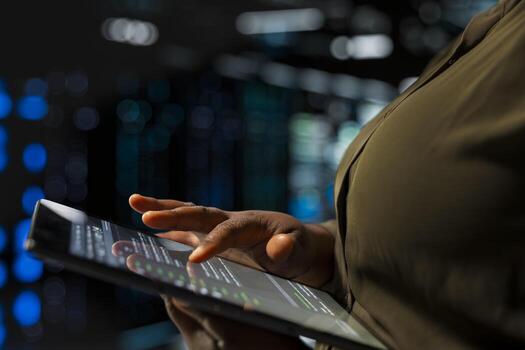 Close up of software developer implementing security measures integral to fortifying data center defenses against cyber threats. Server room expert doing threat detection, defending company systems photo