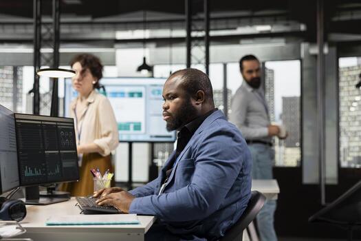 Black manager uses digital technology to forecast business performance in a multinational company office, creating strategy reports leveraging data insights to optimize management efficiency. photo