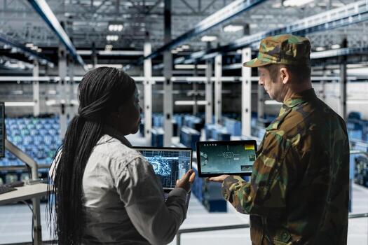 Army soldiers in data center training artificial intelligence to prioritize critical enemy targets. Military units in server room look at AI locking mechanism confirming hostile presence on screen photo