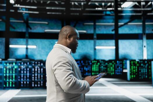 Server hub admin checking recovery plan on tablet, deploying tools to reduce downtime. Data center IT expert monitoring hardware thermal levels, making sure rigs are functioning optimally photo