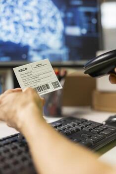 Close up of employee uses AI brain automation and scan shipping labels, registering barcodes with artificial intelligence automation to fulfill e-commerce operations. AI support. photo