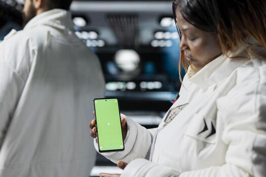 Scientists using chroma key phone in high tech starship during cosmic journey. Cosmonauts travelling in space conducting scientific experiments in orbit using isolated screen smartphone photo