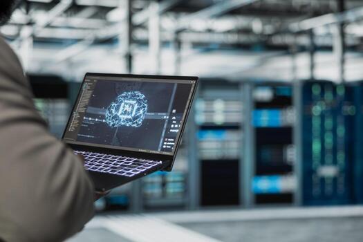 Close up of programmer working in data center providing computing resources and storage to enable AI training and inference. Server farm IT professional using deep learning tech to optimize operations photo