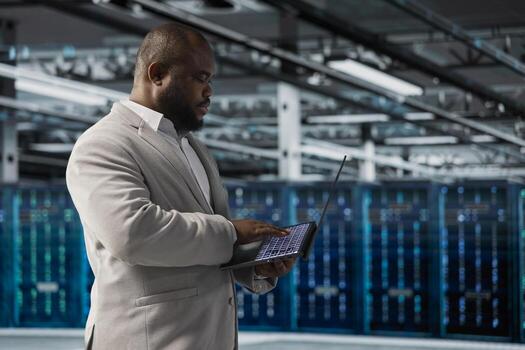 Data center employee running predictive maintenance scans, fixing network issues affecting rigs performance. Technician running system diagnostic tests, tracking resource utilization photo