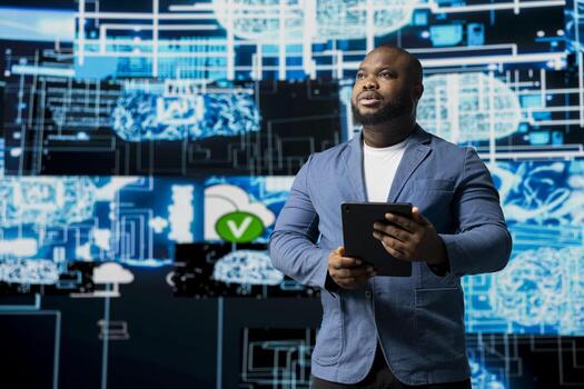 Black male IT engineer examining digital AI brain interface on dashboard, symbolizing neural networks, science and algorithmic thinking. Cybernetics for a high tech machine learning innovation. photo