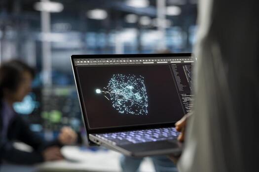 Close up of data center developer using laptop, working on databases supporting AI applications. IT professional uses notebook in server hub, doing algorithms improvements with artificial intelligence photo