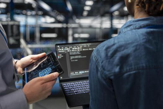 Close up of IT specialists on industrial platform collaborating on servers maintenance with artificial intelligence. Engineers team supporting infrastructure AI machine learning automatization. photo