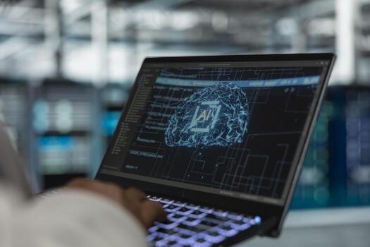 Close up of engineer using laptop in data center housing advanced infrastructure used for AI workloads. Server room IT professional running artificial intelligence code to reduce rigs latency photo