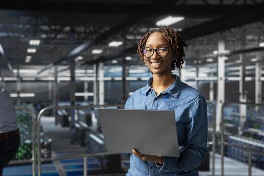 Portrait of black smiling technician monitoring AI LLM visualization on industrial platform in server hub, neural network systems. Female engineer brainstorming ideas for development. photo