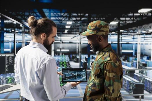 Military server room IT professionals using AI LLM tech on laptop to review network performance. Army operators managing hardware systems supporting armed forces mission for national security. photo