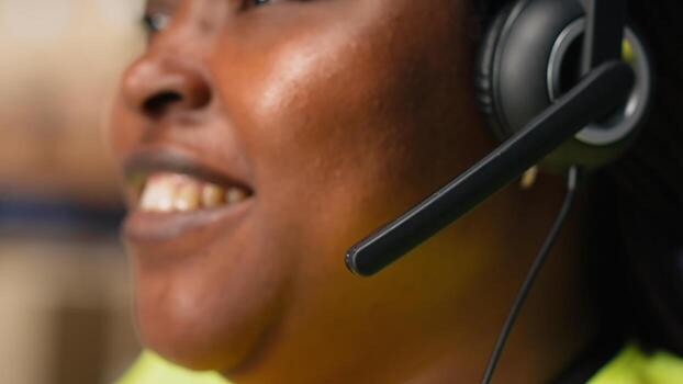Call center clerk parcel tracking and order dispatch on help line, working in an online shopping logistics center. Worker resolving cargo issues and packages lost in distribution process. Camera B. photo