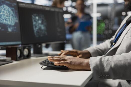 Close up of data center admin coding, using artificial intelligence networks tech. Server farm employee typing on PC keyboard, using AI programming language on computer to update equipment photo