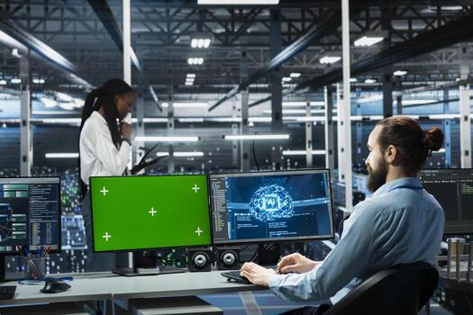 Data center technician monitoring AI systems using green screen mockup PC. Server room IT specialist using chroma key isolated computer, enhancing artificial intelligence performance photo