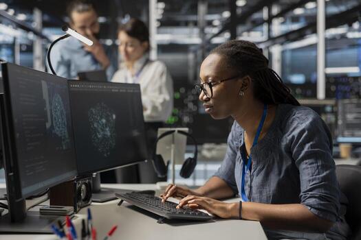 Focused admin in data center using AI powered tech to run simulations. Worker coding cognitive computing algorithms to extract insights from data and automate equipment racks photo