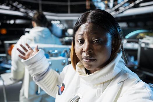 Astronaut doing personal log entry broadcasted from inside space station. Spaceship crew member sharing insights and updates during daily communication routine done for scientists on Earth photo