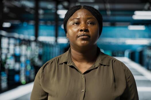 Close up of technician doing maintenance in data center with setup helping companies stay connected. African american worker walks in server farm with machines blinking lights showing system activity photo