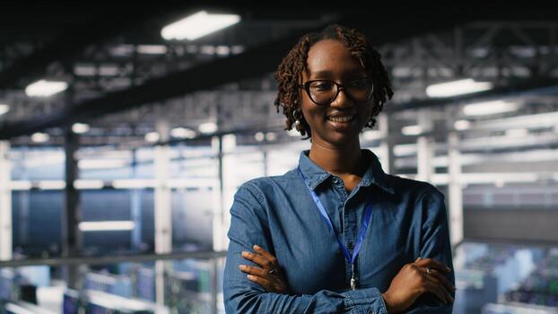 Portrait of smiling data center admin next to coworkers running diagnostics on equipment to identify errors. Happy woman next to IT experts working to prevent failure and minimize downtime photo