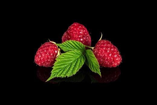 Raspberry isolated. Raspberries with leaf isolate. Raspberry with leaf isolated on black background photo