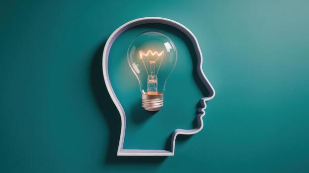 Light Bulb Within a Human Head Outline Against a Teal Background photo