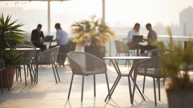 People Working Outdoors on Laptop Computers at an Open Rooftop During the Day photo