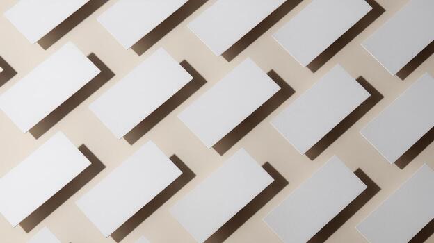 Many White Rectangular Cards Are Arranged Neatly in a Pattern on a Beige Surface photo