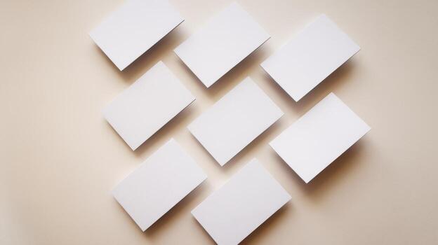 Blank White Rectangular Cards Arranged on a Light Beige Surface photo