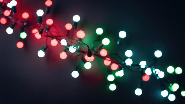 Colorful String of Christmas Lights Shine Against a Dark Background photo
