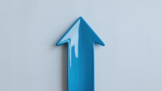 Bright Blue Arrow Pointing Upward on a Light Gray Background Shows Direction photo