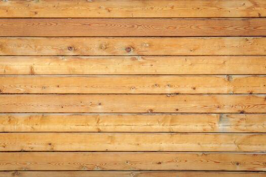 Wooden planks arranged horizontally form a smooth surface with visible grain patterns and natural knots. photo