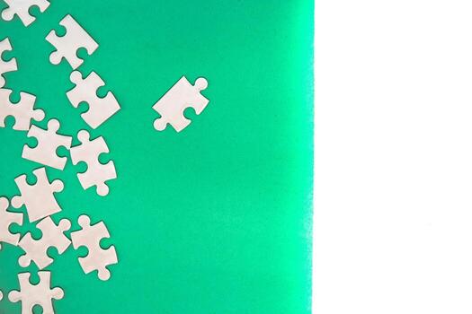 Unfinished White Puzzle on Green Background with a Blank Space, Concept of Problem Solving and Completing Tasks photo