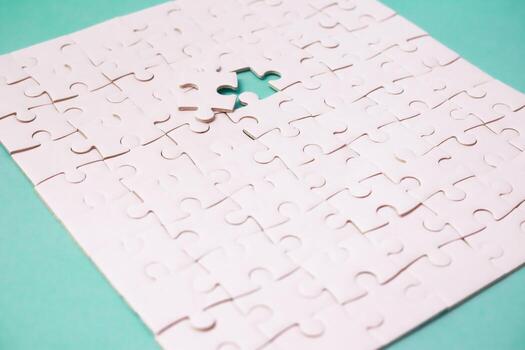 White Jigsaw Puzzle with Missing Piece on a blue background symbolizing incompleteness, challenge and problem-solving photo