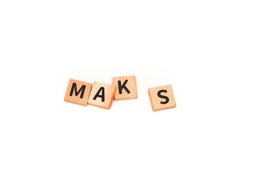Wood tiles spelling the name MAKS isolated against a white background. A simple and clean image for various creative projects photo
