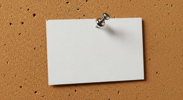 Blank white note pinned to a corkboard showcasing a minimalist design perfect for message and reminder concepts photo