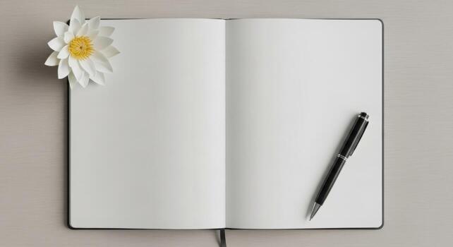Open notebook with a white flower and black pen showcasing a blank page perfect for stationery and branding projects photo