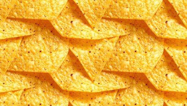 A close-up, grid-like arrangement of many triangular, textured snacks. They are golden yellow, with small dark speckles and varying in orientation photo