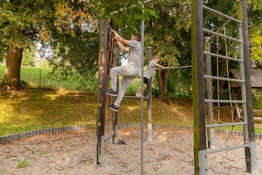un padre es Ayudar su hijo escalada un estructura en un patio de recreo rodeado por arboles ellos son disfrutando calidad hora juntos en el Fresco aire, compartiendo la risa y alegría foto