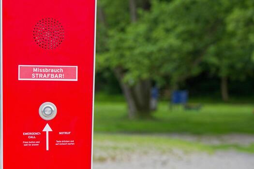 Red emergency call box with speaker port and warning message photo