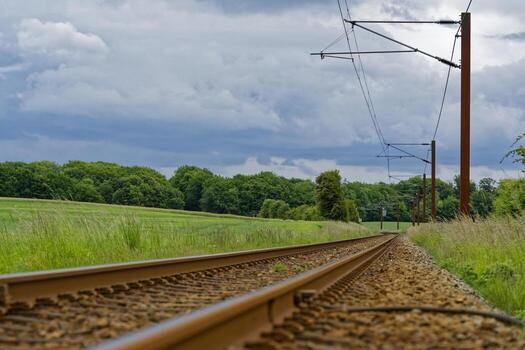 Weathered railway line crossing the edge of open fields photo